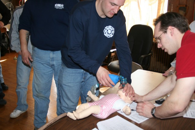 Jeff Assisting A New Firefighter With Ventilating An Infant