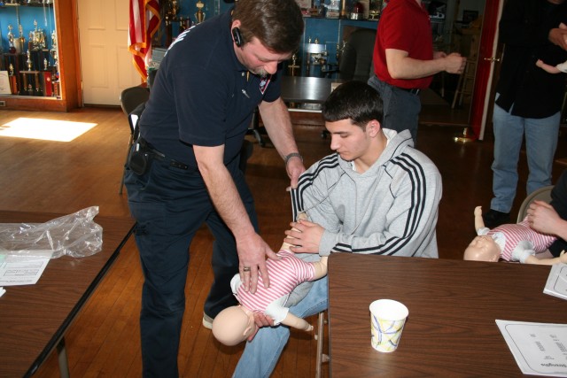 Ken Shows A New Firefighter How To Perform Back Blows On A Chocking Infant