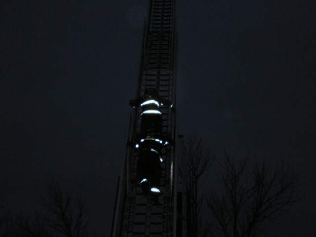 A Probie Starts Up The Ladder With A Senior Firefighter Following Close Behind
