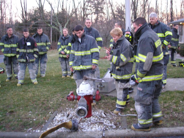 New Firefighters Learning How To Hook Up To A Hydrant