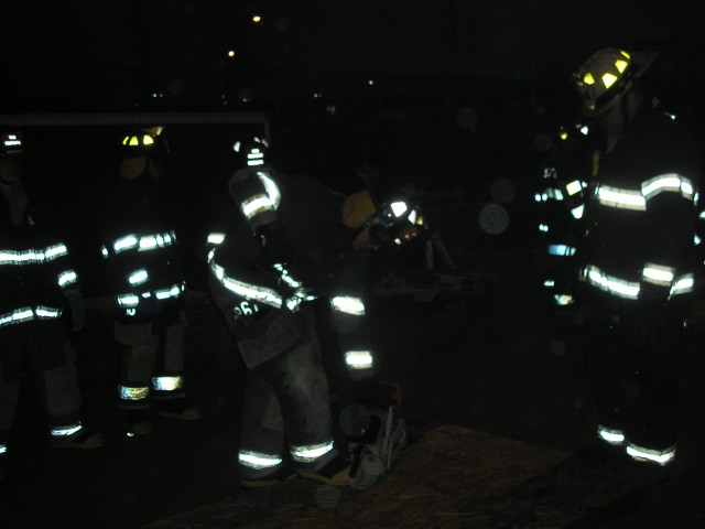 New Firefighters Being Taught Proper Roof Ventilation Techniques Before They Go Up On The Roof Simulator