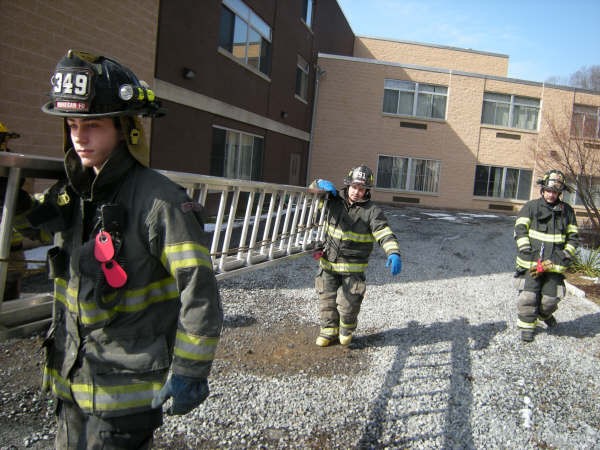 FF Lentini And FF Ocasio Carry Ladder At Drill In March, 2009