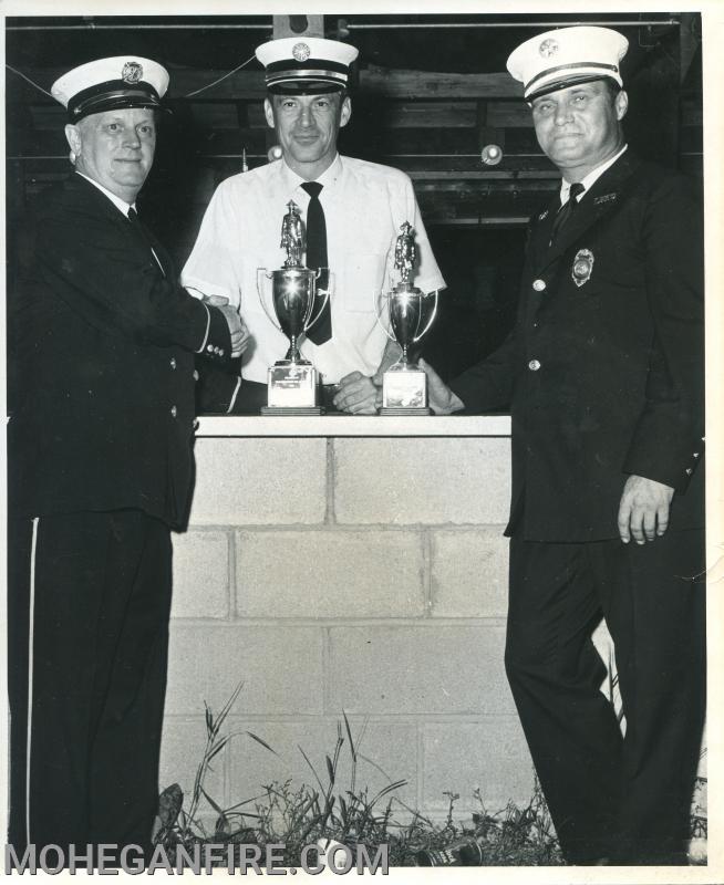 Chief Cal Curry on the right excepting a trophy after a parade
